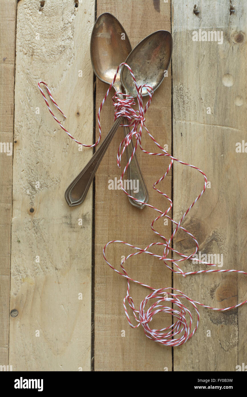 Vintage metal spoons on wooden table close-up Stock Photo