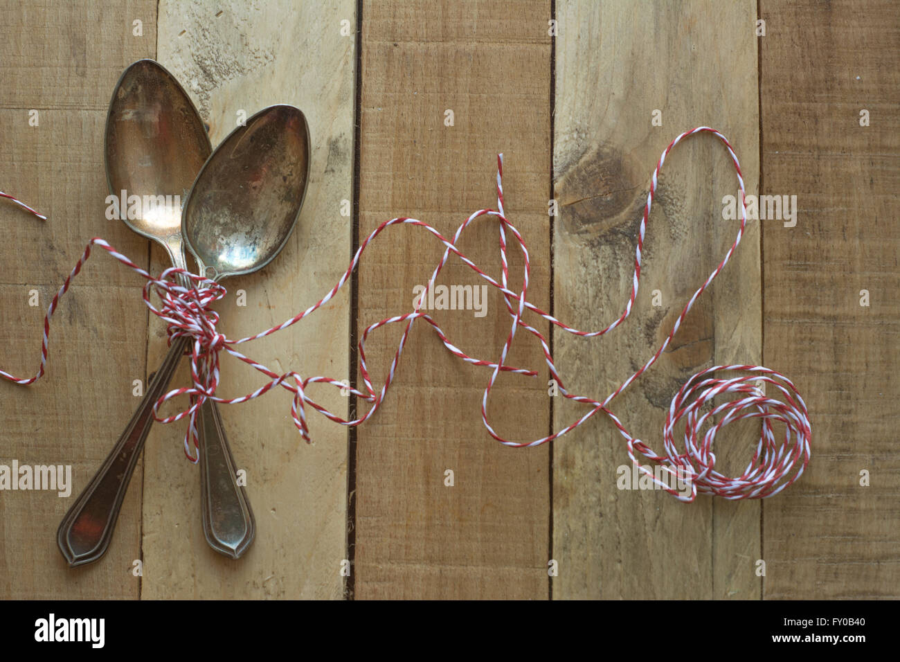 Vintage metal spoons on wooden table close-up Stock Photo