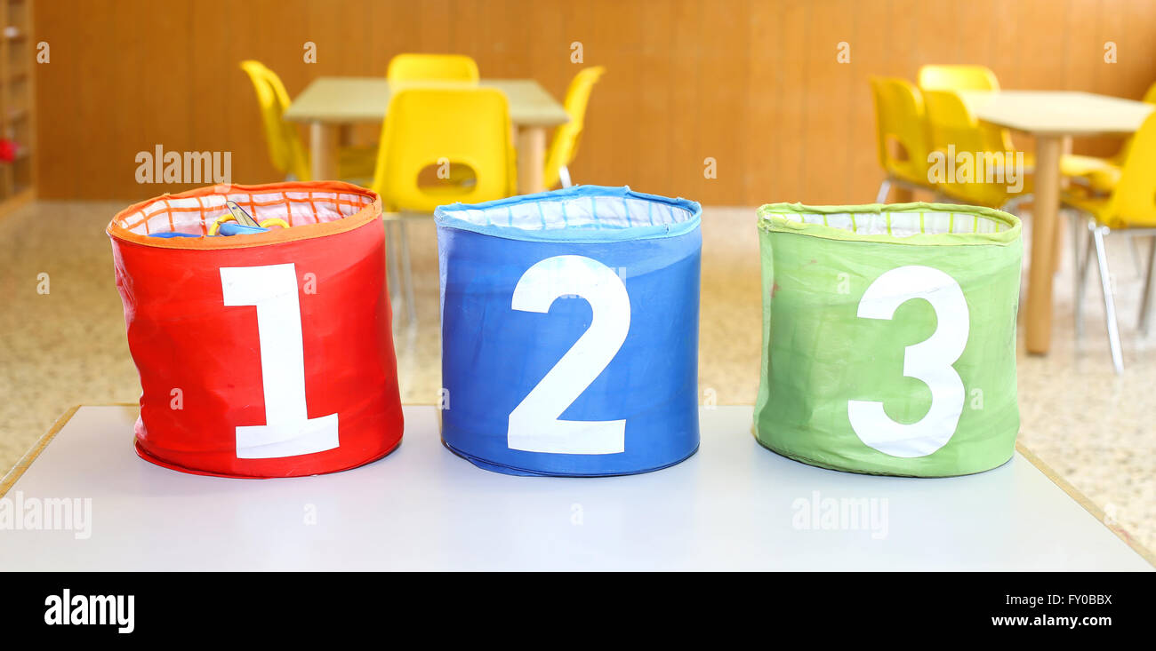 Three containers for toys with numbers one two three in a classroom of kindergarten Stock Photo