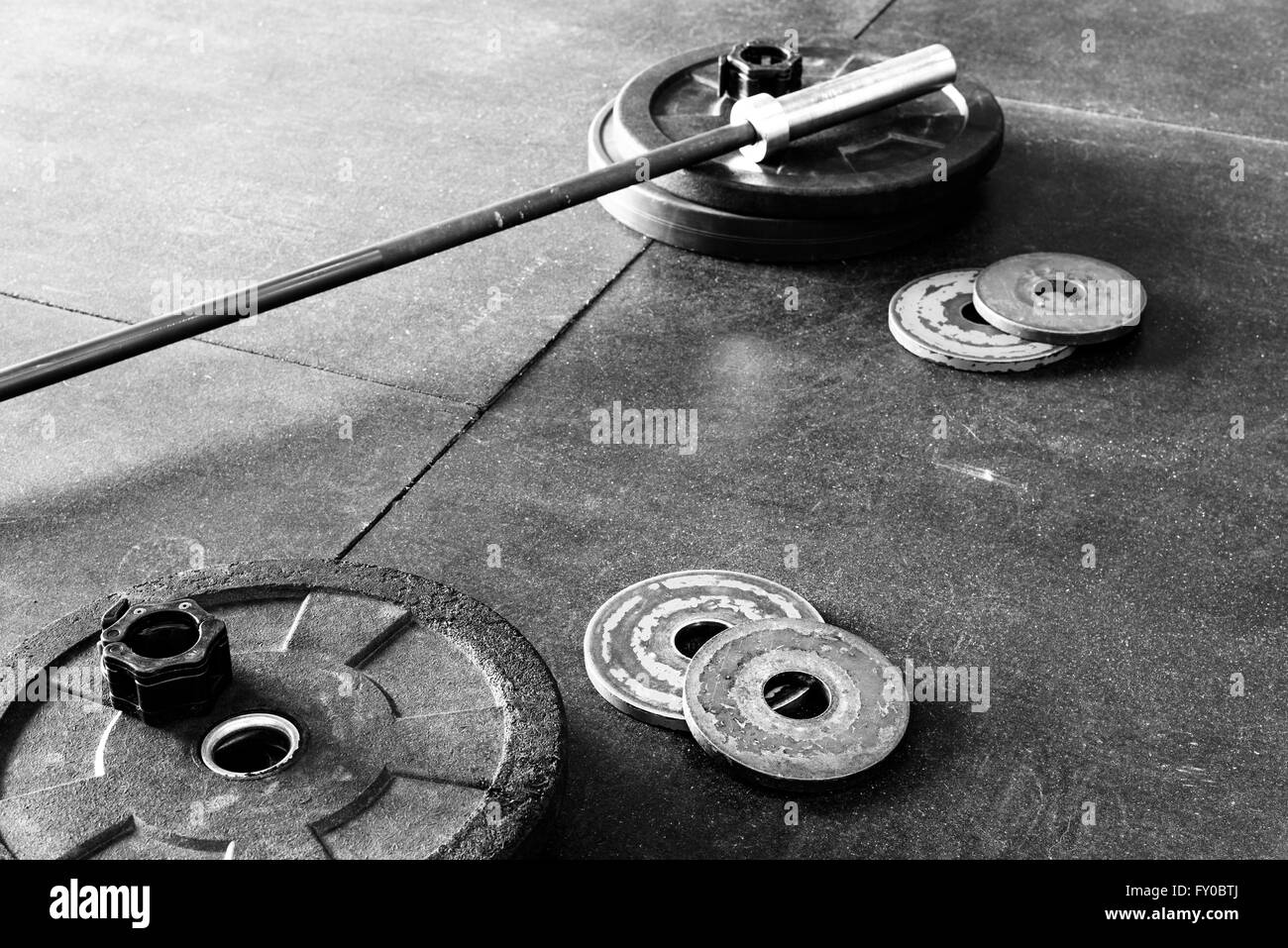 Barbell and weights on a gym floor, in black and white Stock Photo