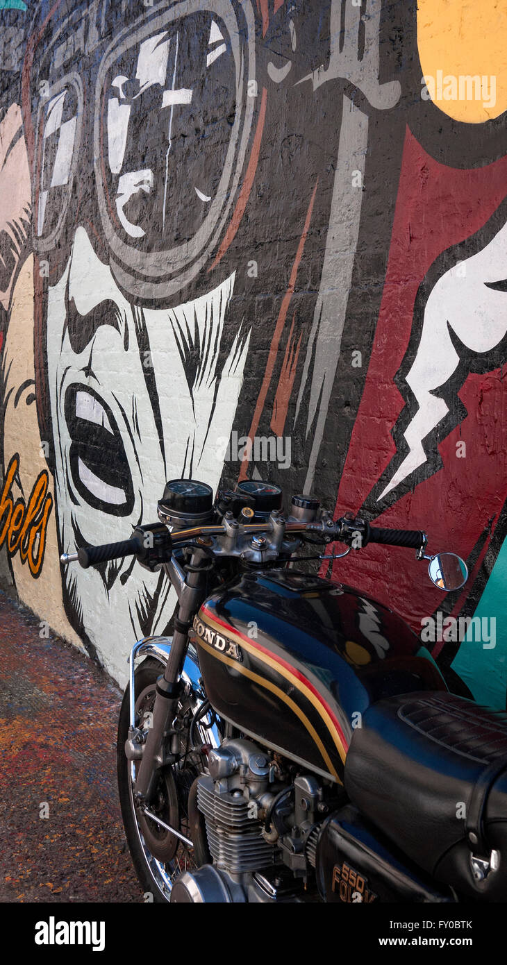 Classic Honda  550K Four motorcycle parked next to street art near Brick Lane Shoreditch London UK Stock Photo