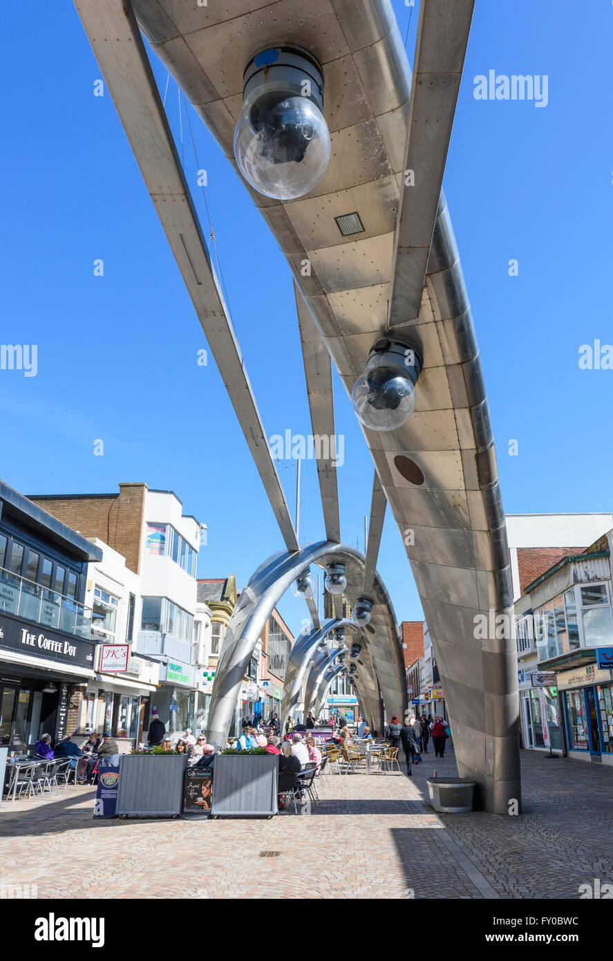 Under a blue sky, tourists drink and eat at cafés in Church Street, Blackpool famous for it's very modern street lighting Stock Photo