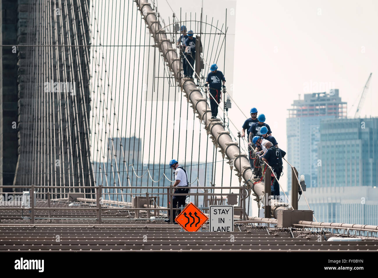 NEW YORK CITY, USA - JUNE 12, 2015: NYPD ESU officers climb down the brooklyn bridge Stock Photo