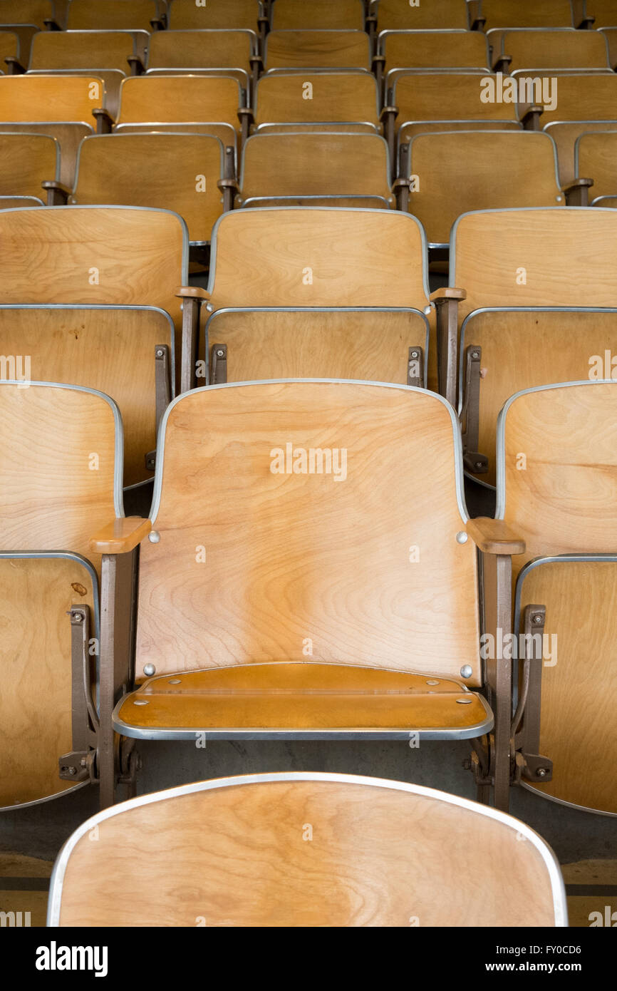 Empty folding wooden university auditorium seats in an empty classroom Stock Photo