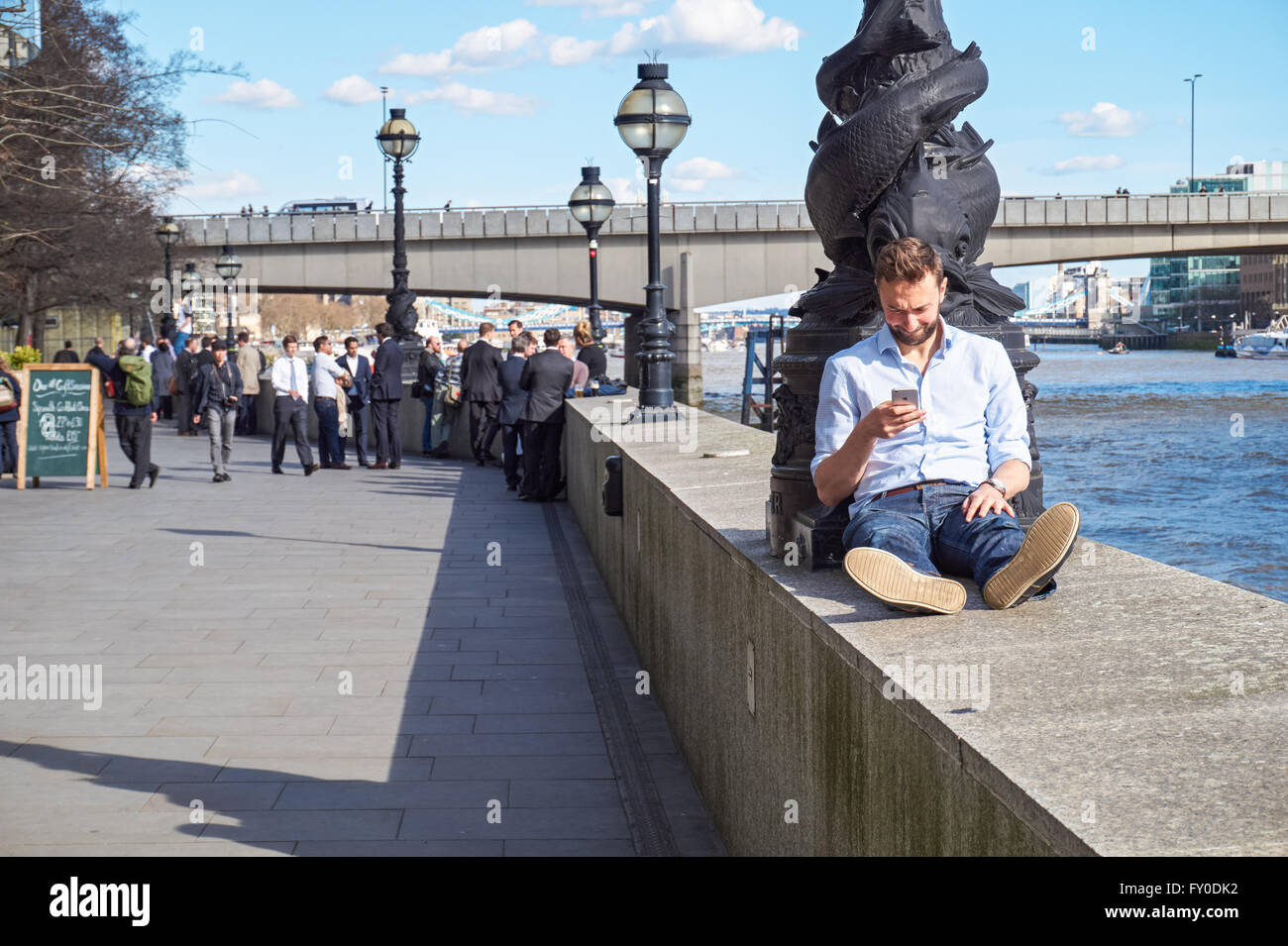 People outside the Oyster Shed bar next to the River Thames and London Bridge, London England United Kingdom UK Stock Photo