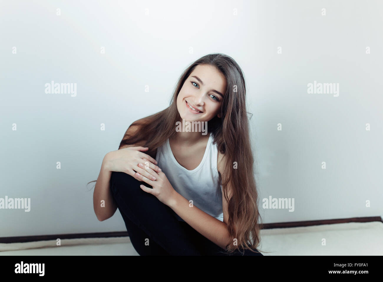 young beautiful girl posing on a white background Stock Photo - Alamy