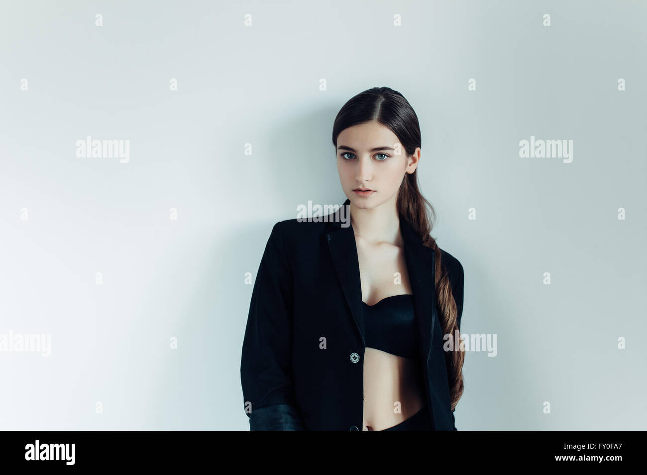 young beautiful girl posing on a white background Stock Photo - Alamy