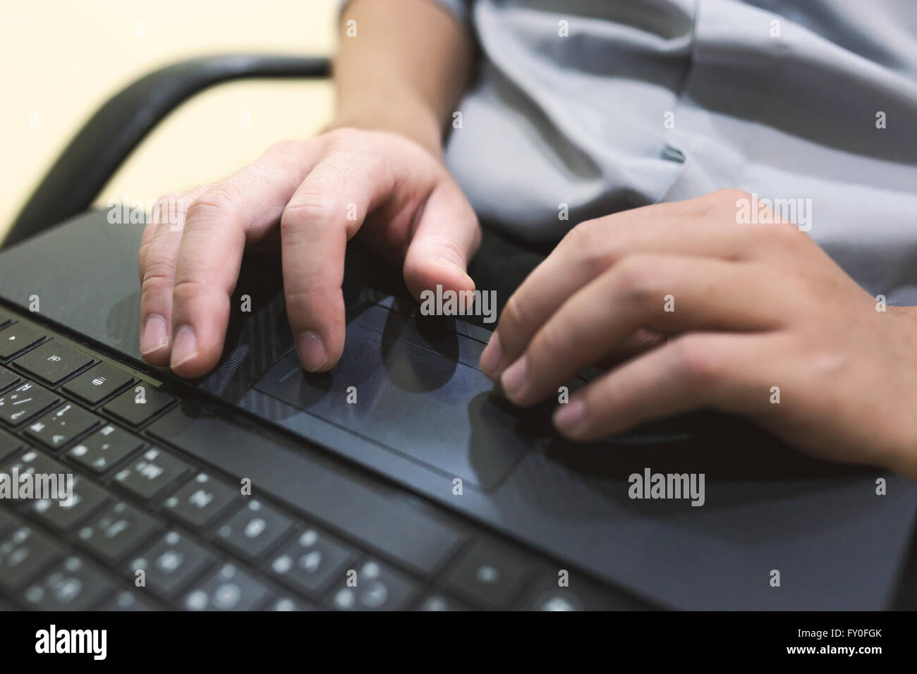 Adult man sit and typing laptop on your leg in home office . Stock Photo