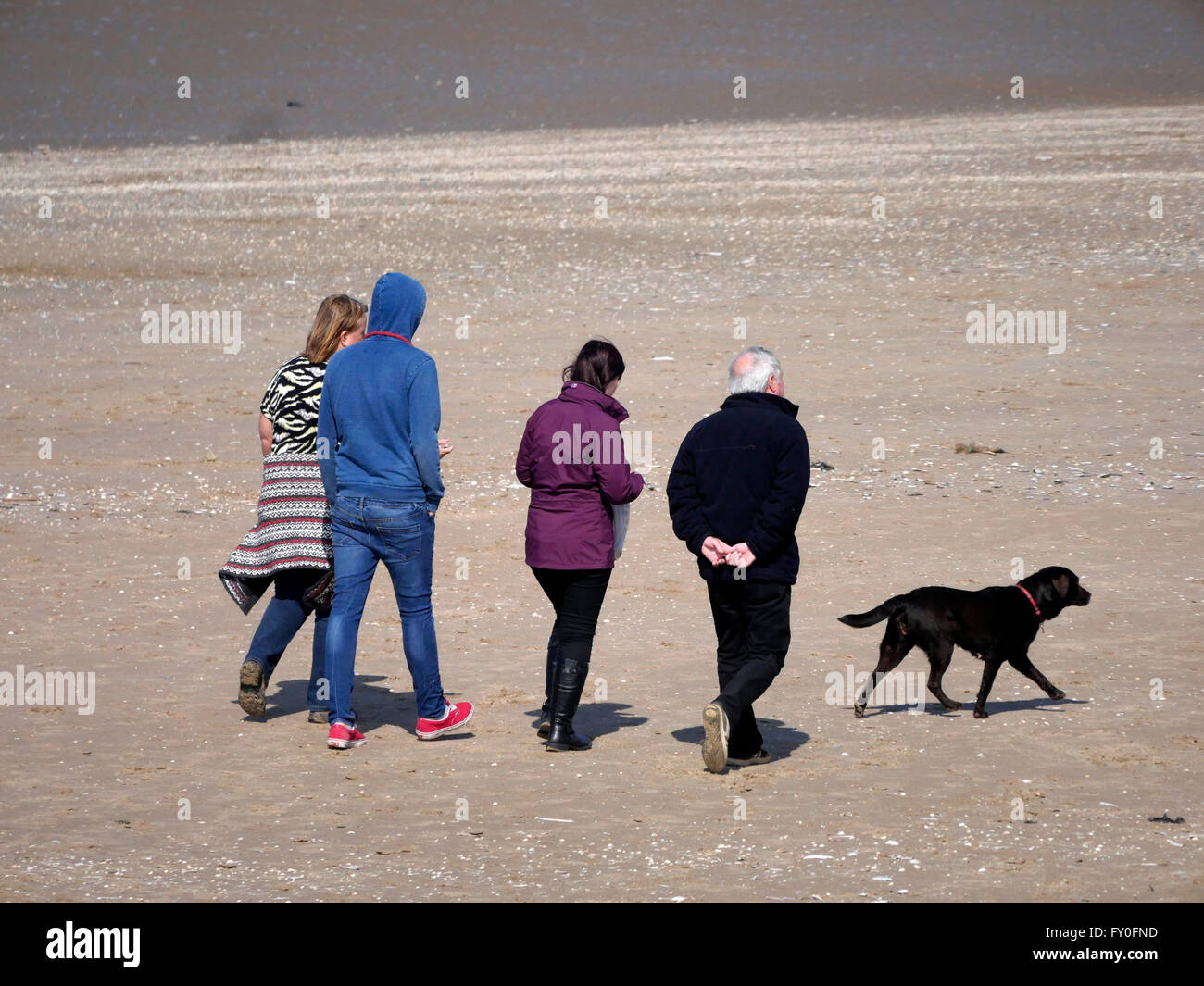 Weather Sunny Day in New Brighton  Merseyside. UK 3 April 2016. Bright sunny day. People enjoy a walk on the beach.© Alan Edwards/Alamy Live News Stock Photo