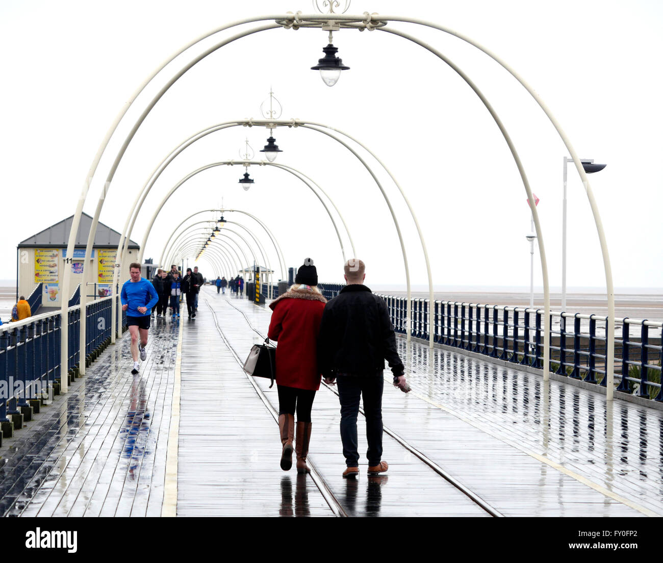 Weather Southport Merseyside UK. 2 April 2016. People out and about on a rainy Saturday in Southport Merseyside UK Stock Photo