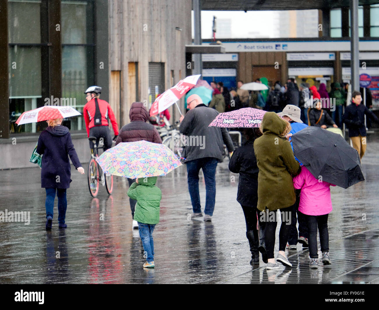 UK Weather. Greenwich London. UK. 27 March 2016. People out and about in the wind and rain in Greenwich London. Easter Sunday 2016. Stock Photo