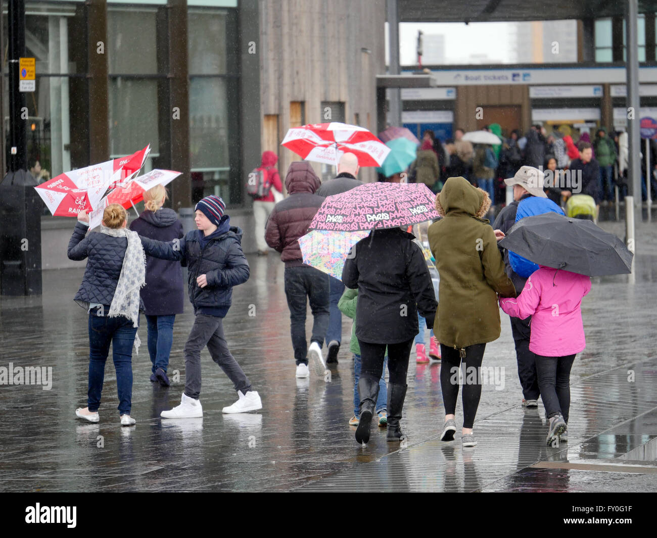 UK Weather. Greenwich London. UK. 27 March 2016. People out and about in the wind and rain in Greenwich London. Easter Sunday 2016. Stock Photo