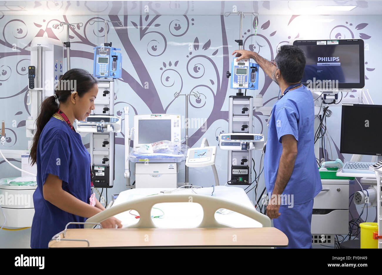 Doctor and Nurse preparing a hospital bed on a private ward in the UK