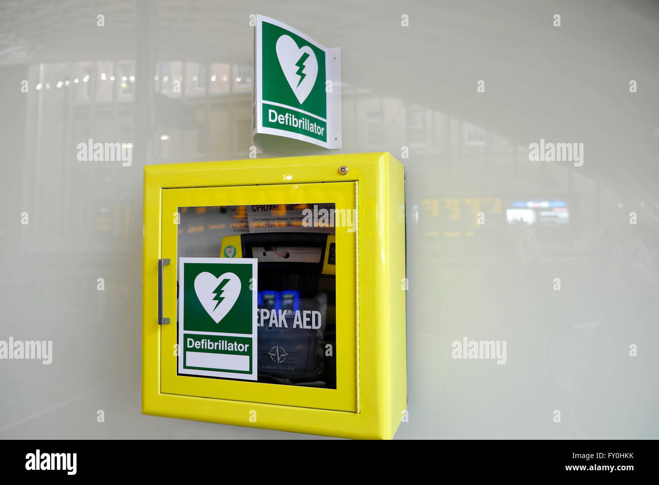 Defibrillator on a wall in a public area of Kings Cross Station in London UK  KATHY DEWITT Stock Photo