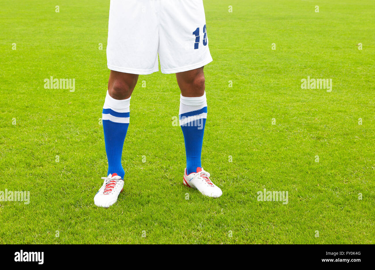 Football player dressed in white and blue in the ground Stock Photo