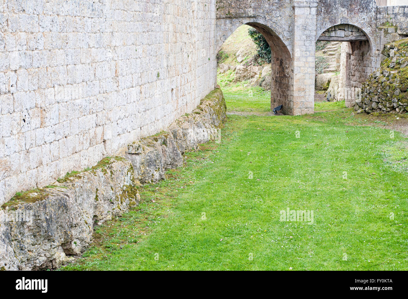Stone arches in the moat outside the medieval fortified city of Larressingle. Gers. France. Stock Photo