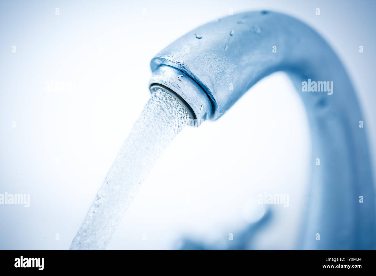 Running water tap closeup in toning Stock Photo