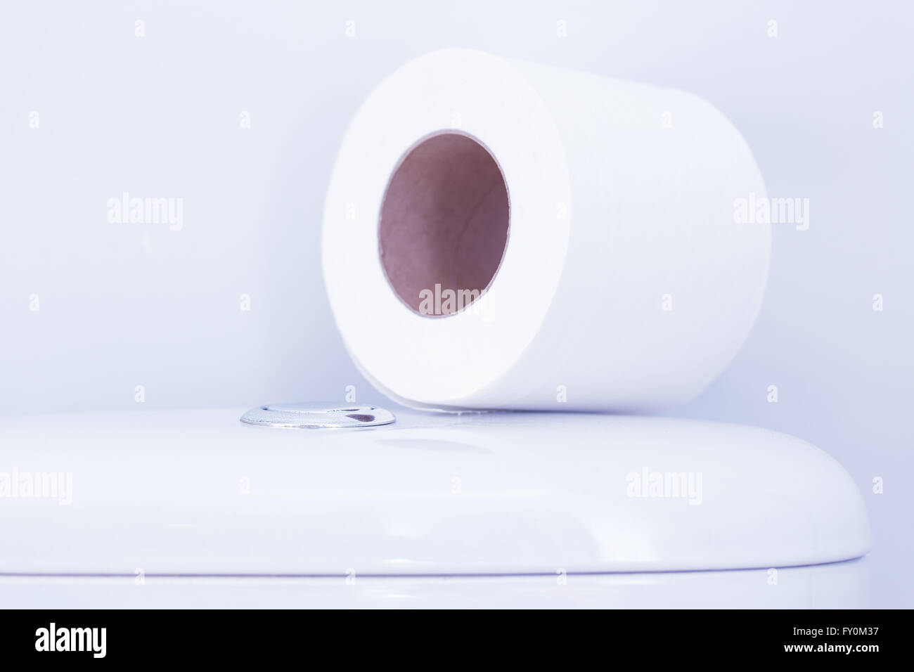 Hygienic paper on white toilet tank closeup Stock Photo
