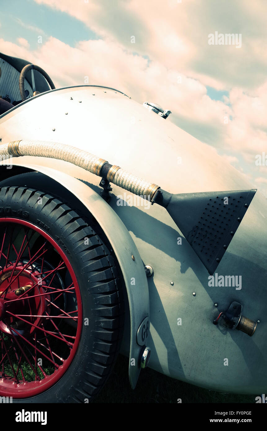 Trumpet exhaust on old classic race car with red wire wheels Stock Photo