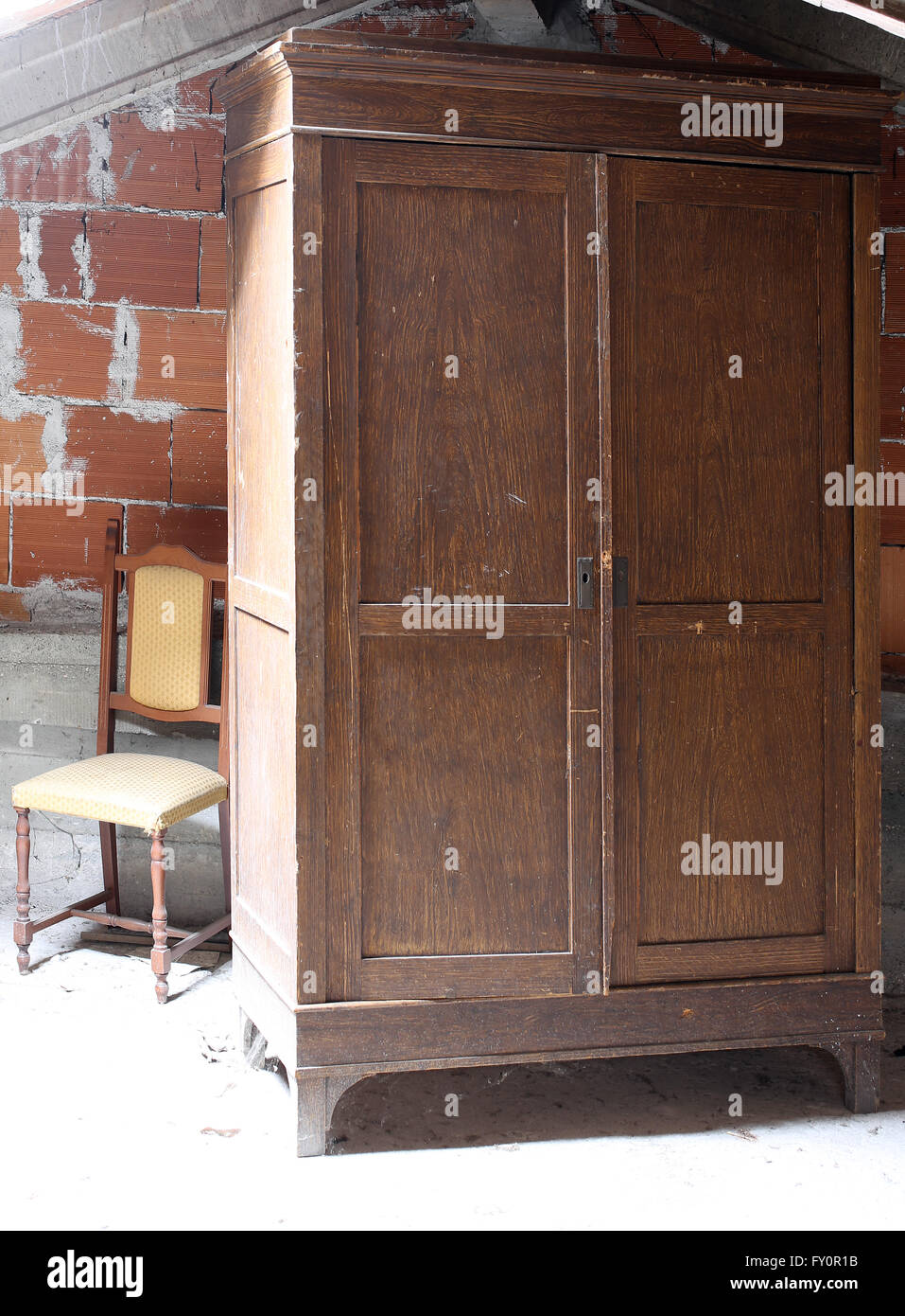 Antique Wooden Wardrobe In The Dusty Attic Of Old House And An Old