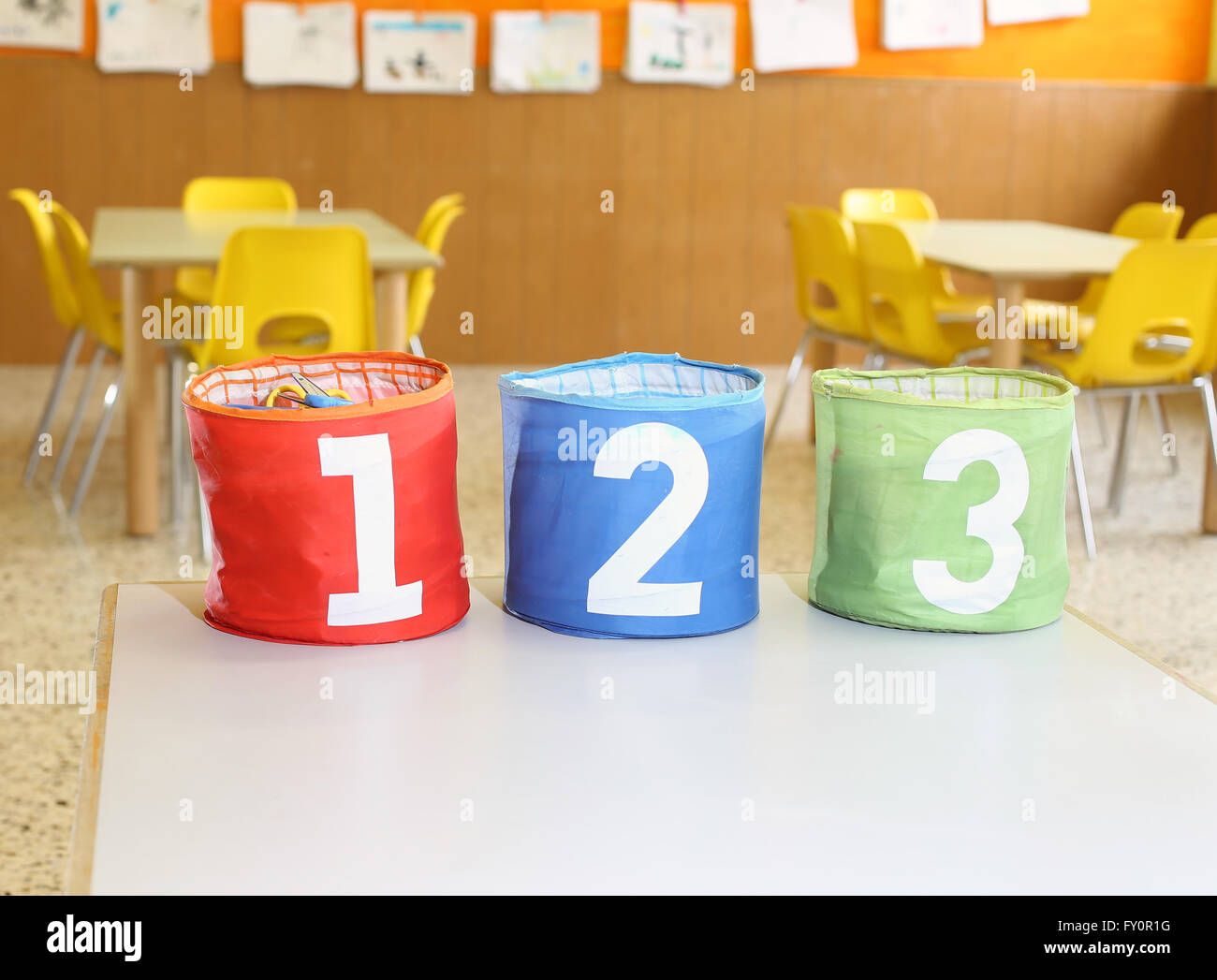 big containers for toys with numbers one two three in a class of kindergarten Stock Photo
