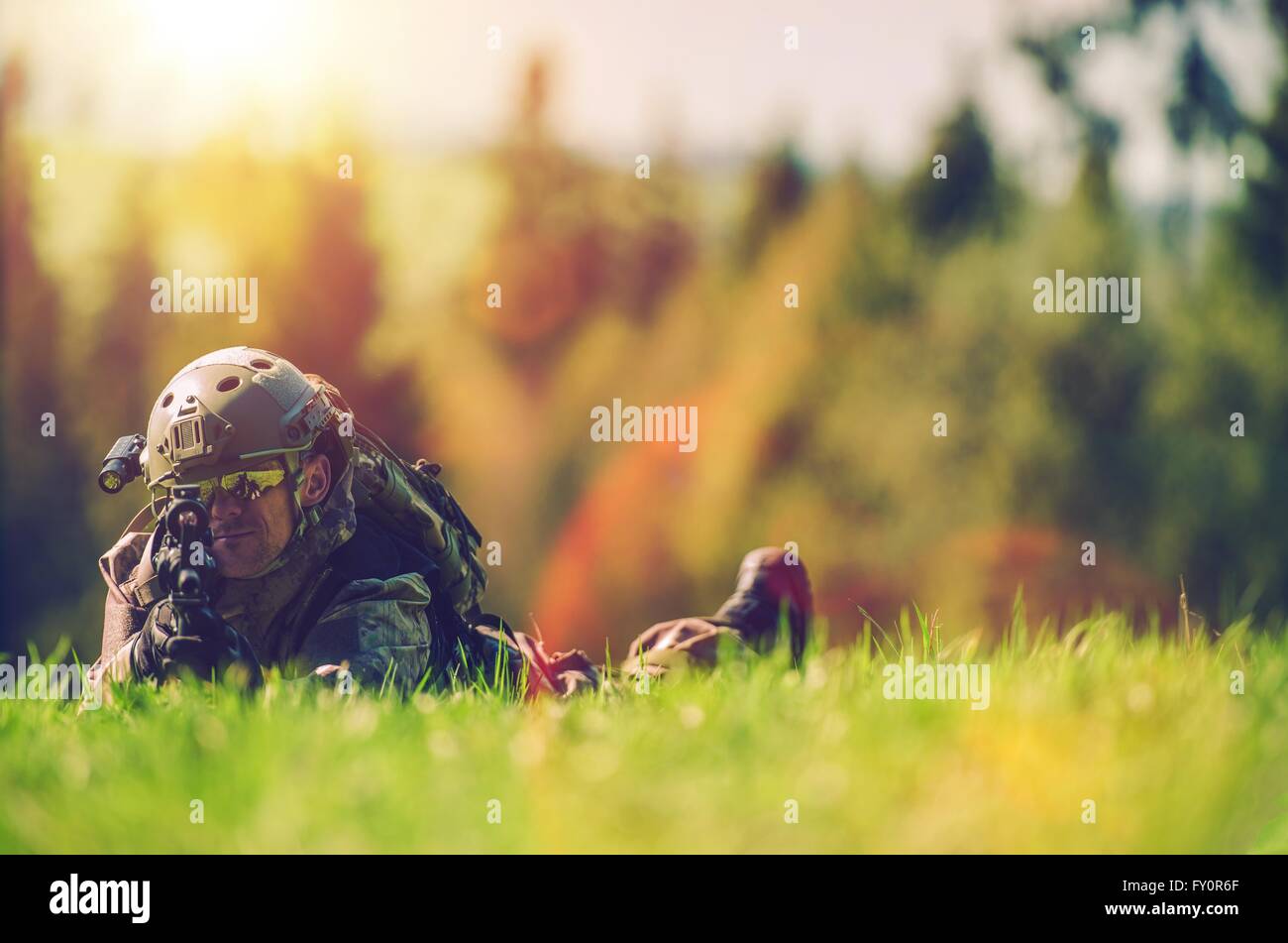 Soldier with Rifle Spotting Enemy While Laying on the Grass, Army and