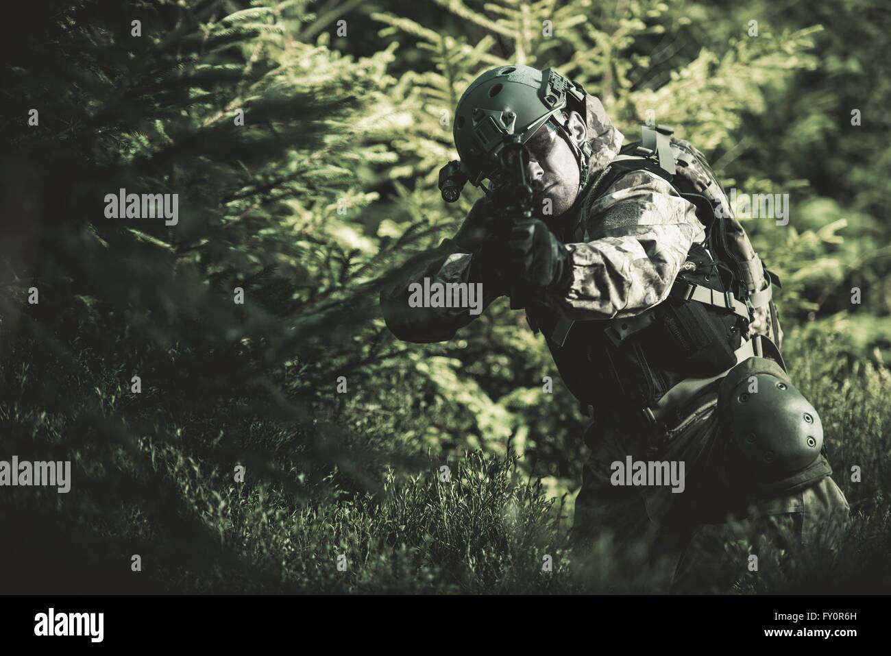 Special Forces Soldier. Camouflaged Marine Soldier Shooting Assault Rifle. Army Military Mission Concept Photo. Stock Photo