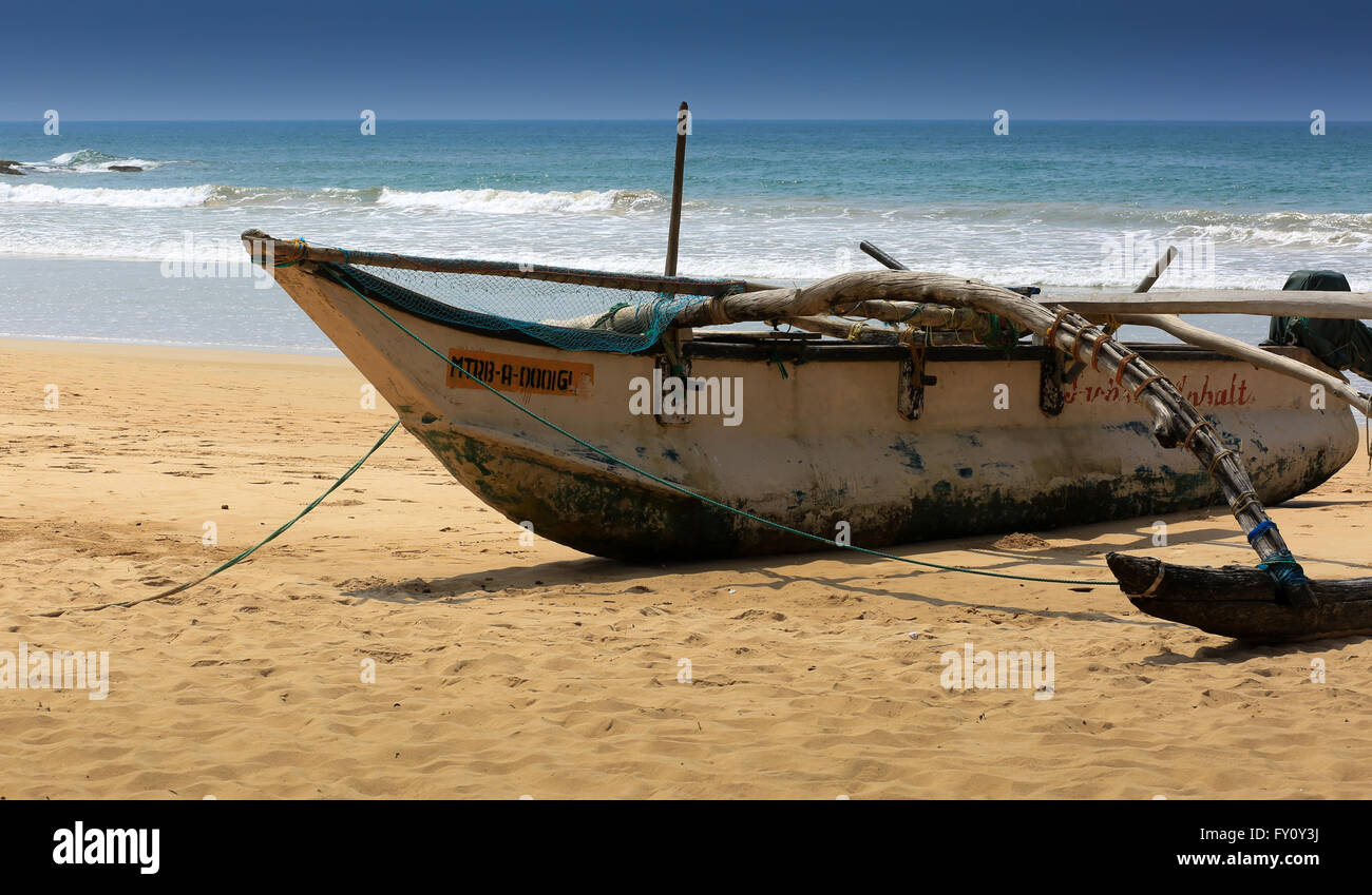 Fishing boat, Bentota, Sri Lanka. Traditional boat is ready to go to the ocean. Stock Photo