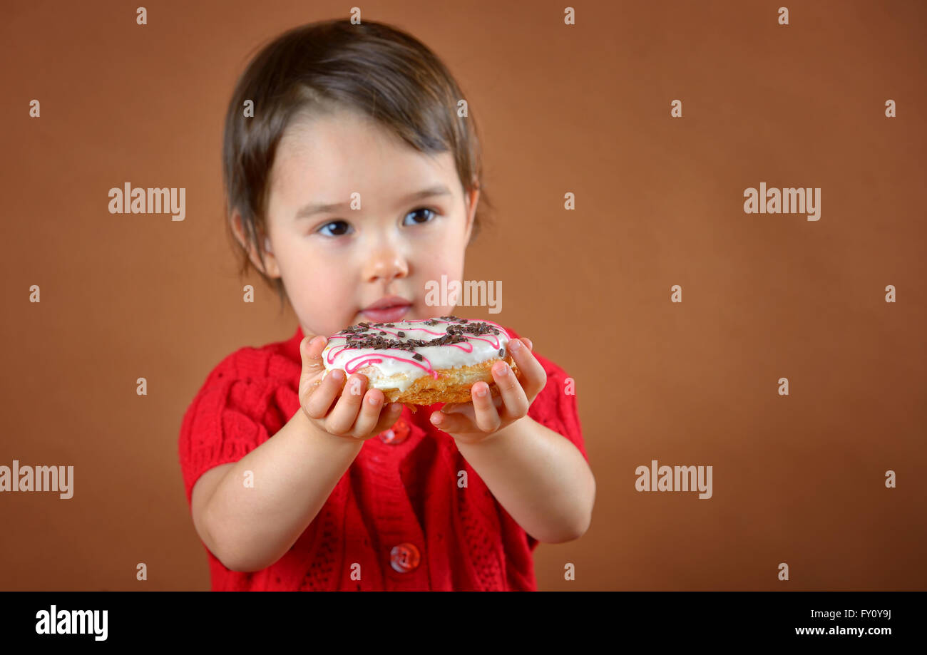 little girl holding donuts shoot in studio Stock Photo
