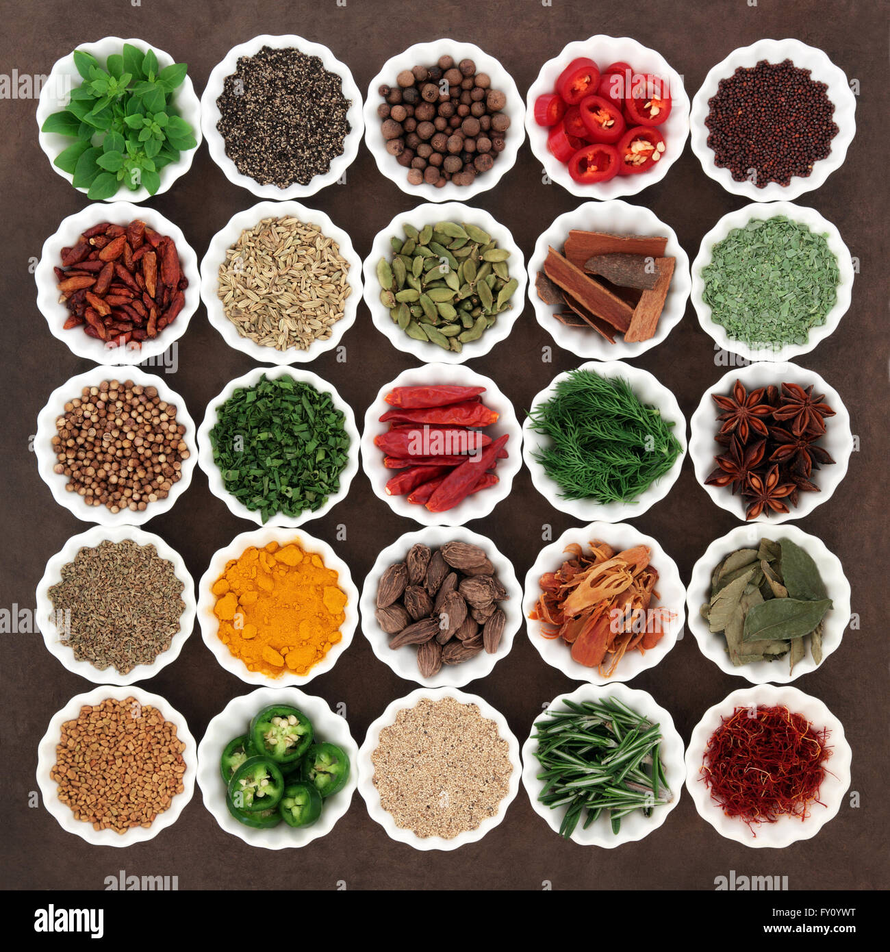 Large spice and herb selection in porcelain crinkle bowls. Stock Photo