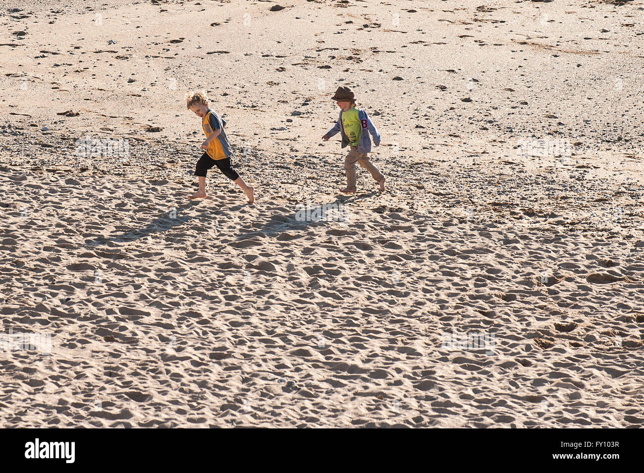 Two young boys playing on the sand at Fistral Beach in Newquay, Cornwall. Stock Photo