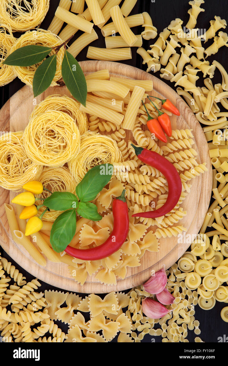 Italian food ingredients with pasta, herb and spice selection on a
