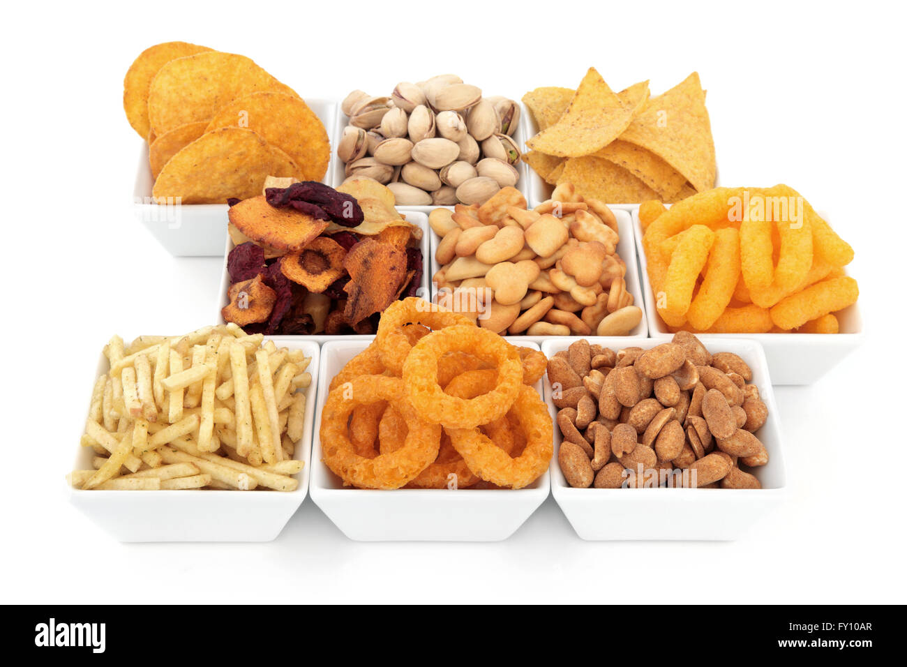 Savoury snack party food selection in square porcelain bowls over white background. Stock Photo