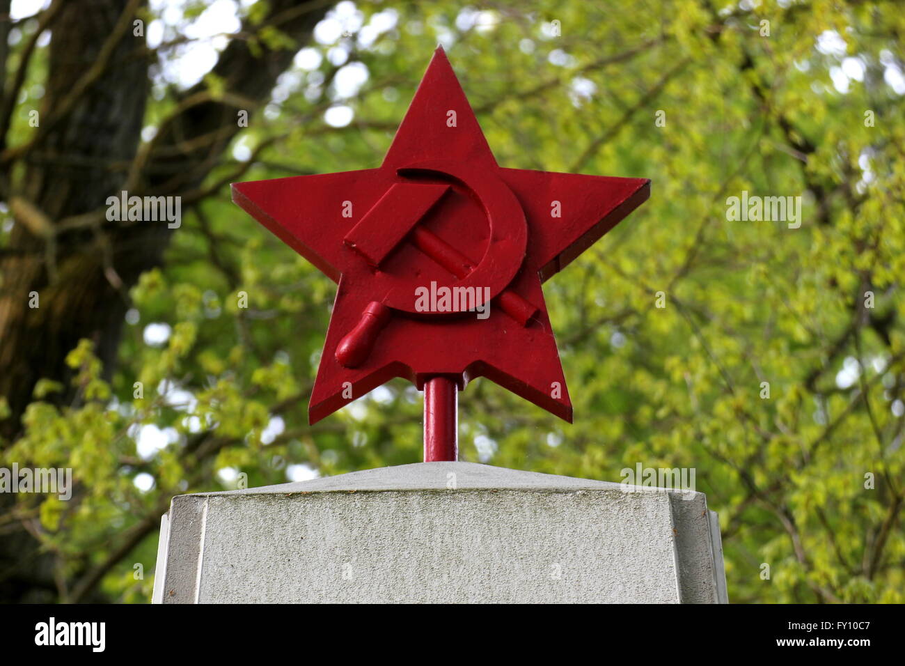 Red star with hammer and sickle, a memorial for the fallen russian soldiers in WWII, on a cemetary in Greifswald, Germany. Stock Photo