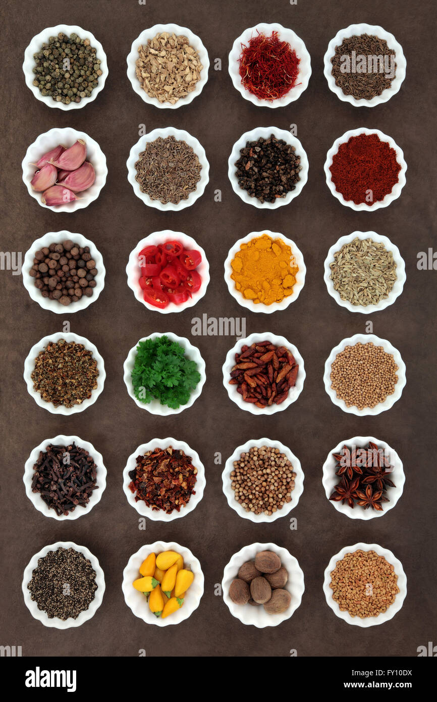 Large herb and spice selection in porcelain crinkle bowls. Stock Photo