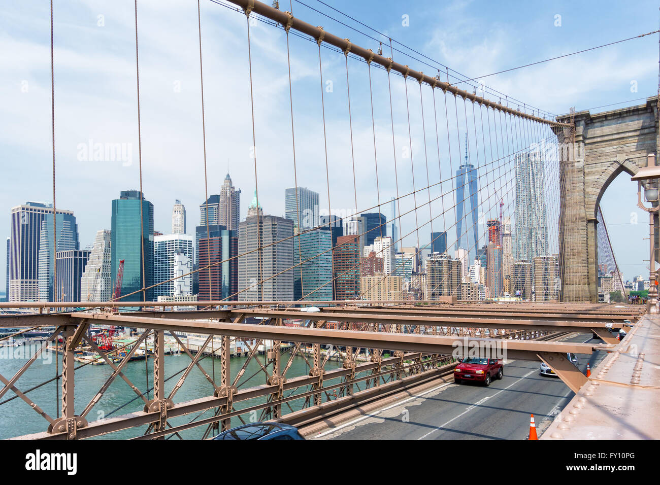 Manhattan Skyline through Brooklyn Bridge, New York City Stock Photo