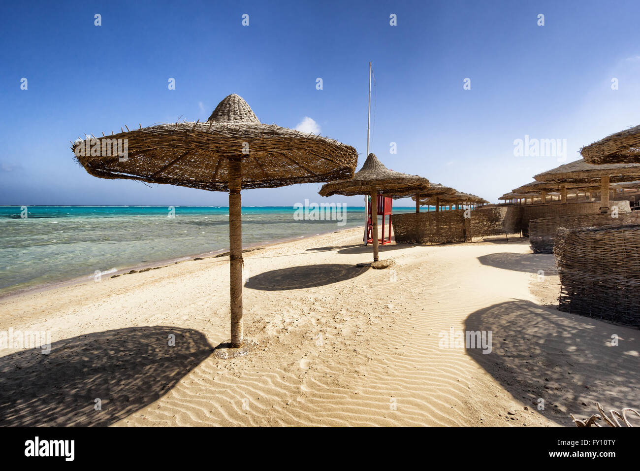 Marsa Alam beach with row of umbrella, Egypt Stock Photo