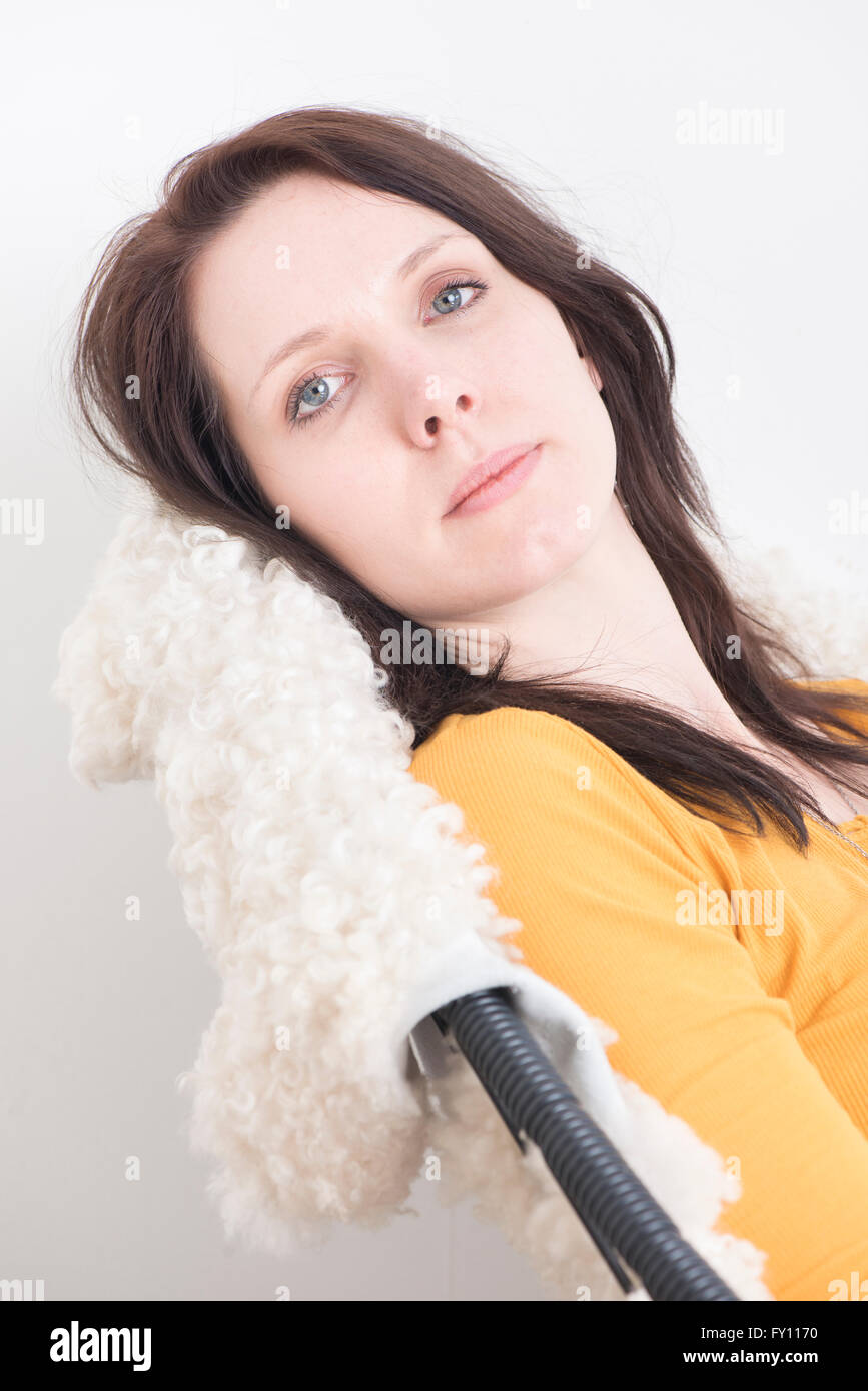 Woman sitting in chair, relaxing. Concept of boredom, loneliness and contemplation. Stock Photo