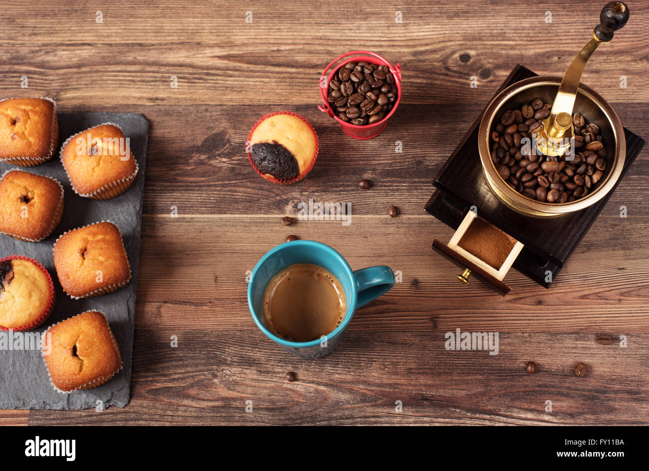 Retro coffee grinder, coffee mill coffee cup, chocolate cupcake, muffins, coffee beans. Still