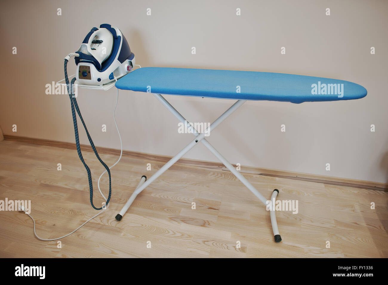 Ironing board with steam iron system Stock Photo Alamy