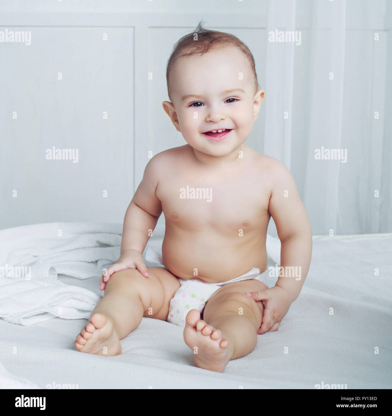 one year old baby wearing diapers in bed at home Stock Photo Alamy
