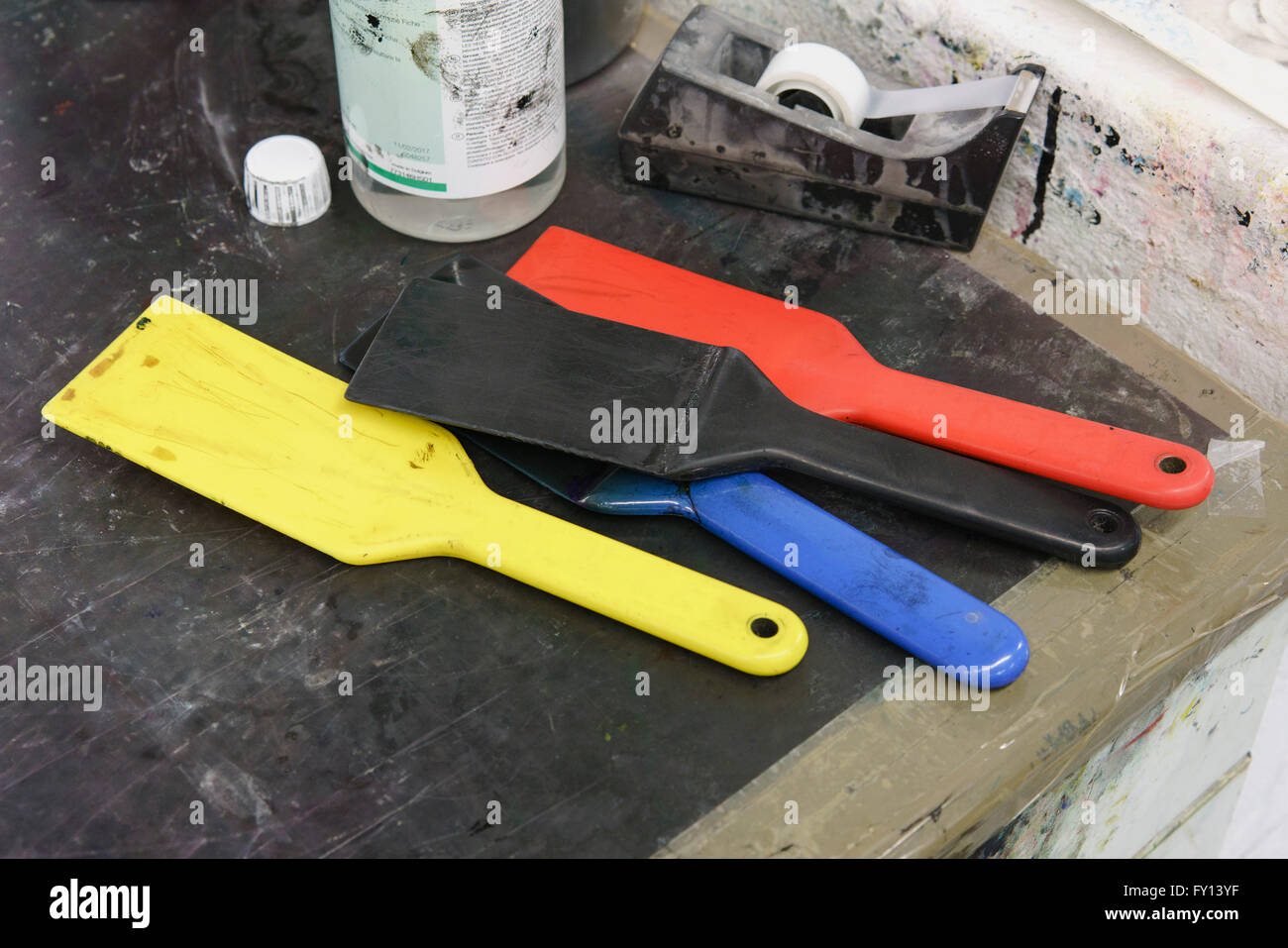 High angle view of tools and adhesive tape on table at printing press Stock Photo