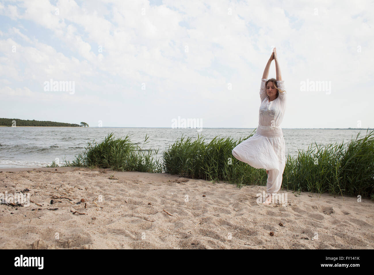 Woman standing sea raised arms hi-res stock photography and images - Alamy