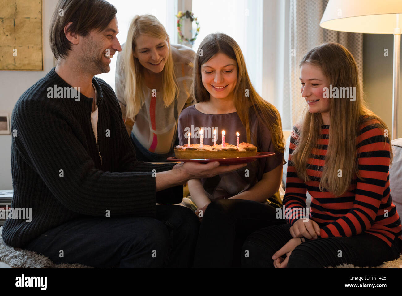 Happy family with birthday cake at home Stock Photo