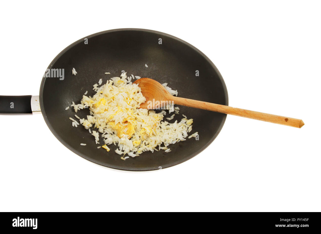 Egg fried rice wih a wooden spoon in a wok isolated against white Stock Photo