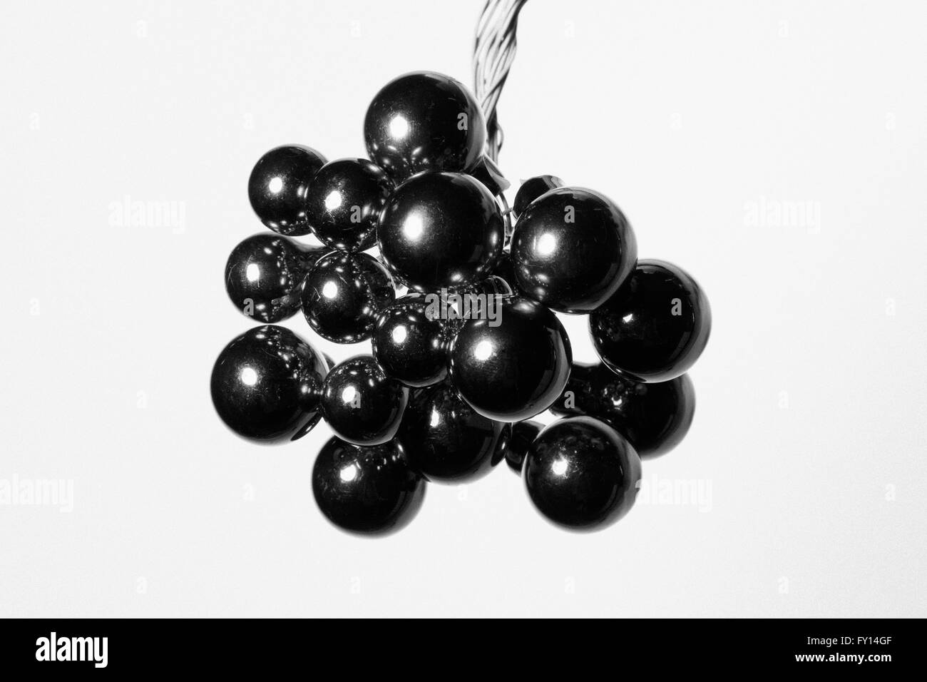 Close-up of black shiny Christmas ornament against white background Stock Photo
