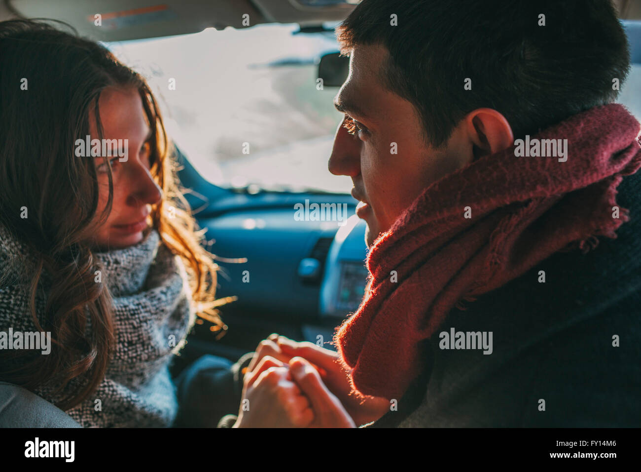 Young couple holding hands in car Stock Photo