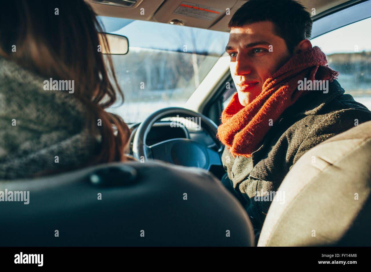 Young woman staring at woman in car Stock Photo