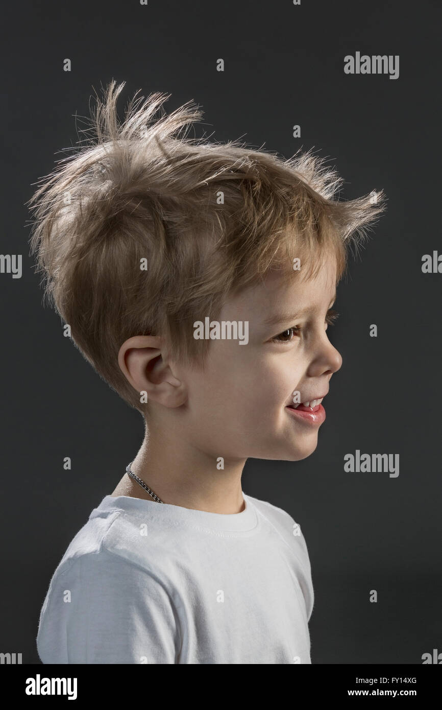 Close-up of happy boy against black background Stock Photo