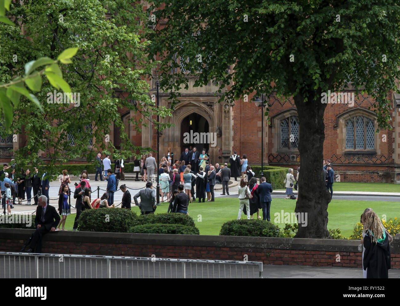 Students and their families at a UK university graduation day outside The Lanyon Building at The Queens University of Belfast. Stock Photo
